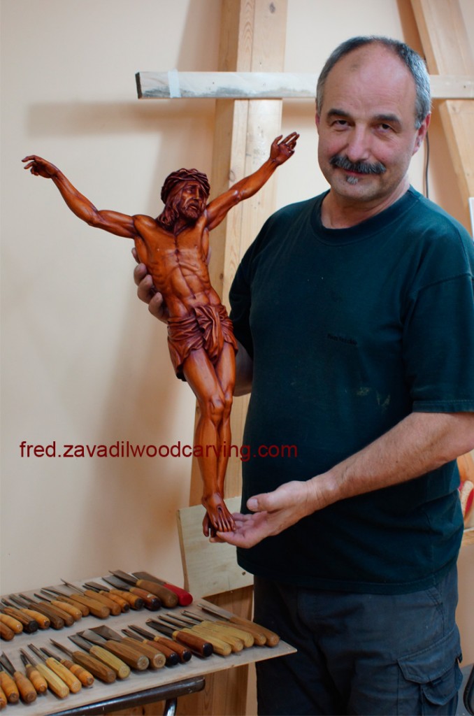 Fred showing custom carved sculpture of Jesus. Stained basswood